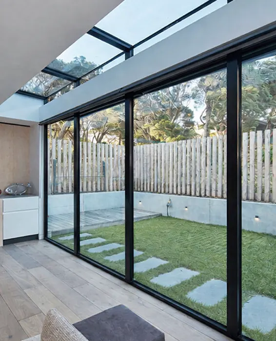 Glass conservatory with aluminum frame attached to residential home